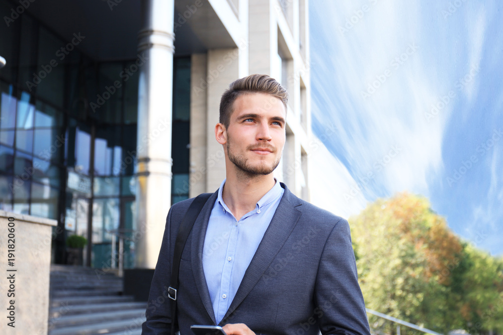 Young urban businessman professional on smartphone walking in street using mobile phone. Young urban businessman professional on smartphone walking in street using mobile phone.