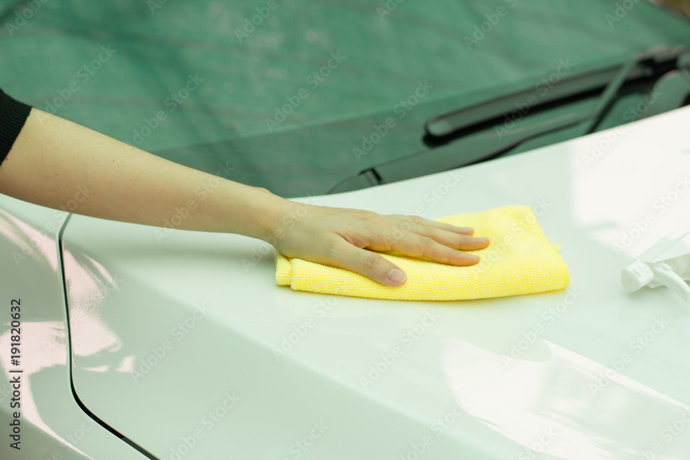 Close up woman hand cleaning car by micro fiber cloth. 