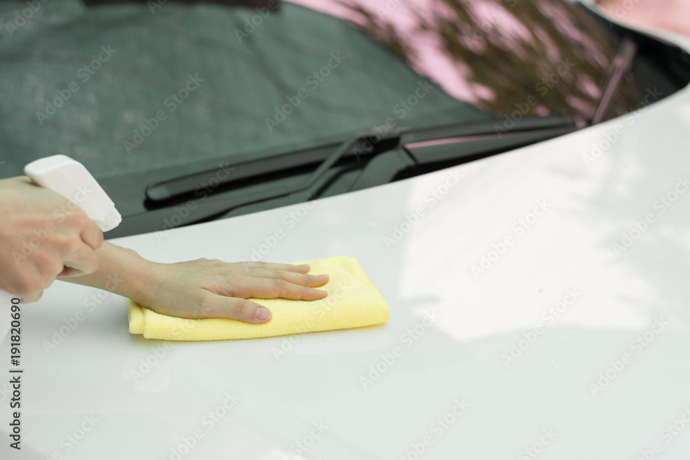Close up woman hand cleaning car by micro fiber cloth. 