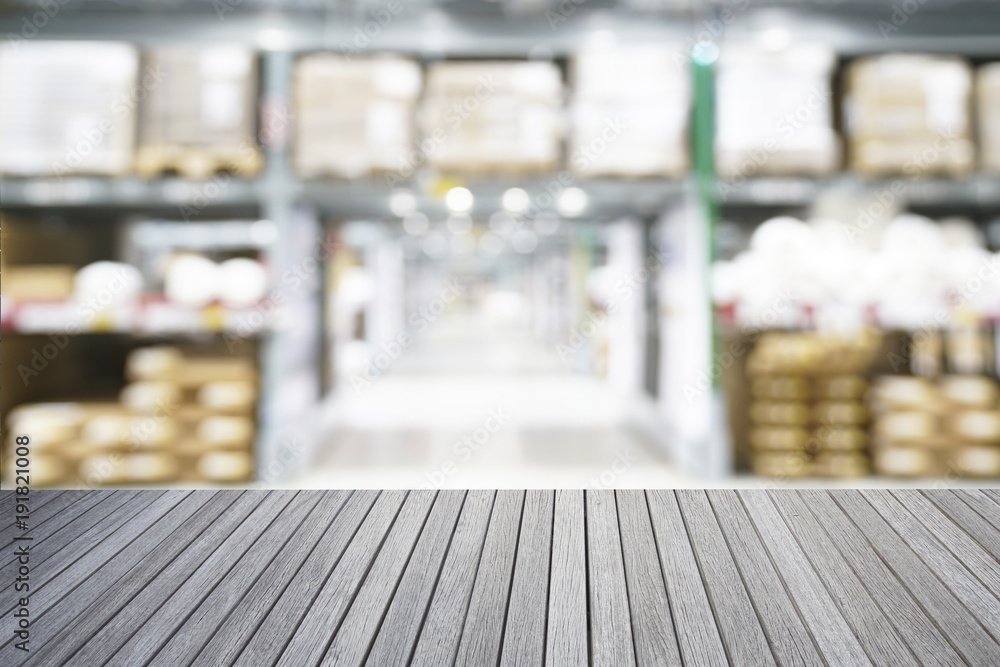 Fototapeta premium Empty top of wooden table and blurred warehouse background for display your products