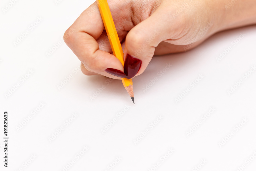 Woman hand with pencil on a white background Woman hand with pencil on a white background