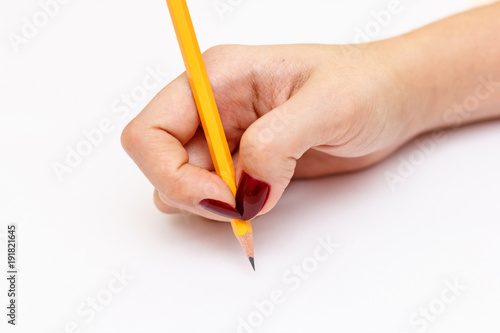 Woman hand with pencil on a white background