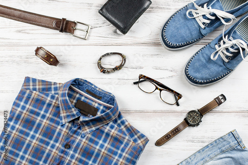 Men stylish casual clothing and accessories on wooden background.