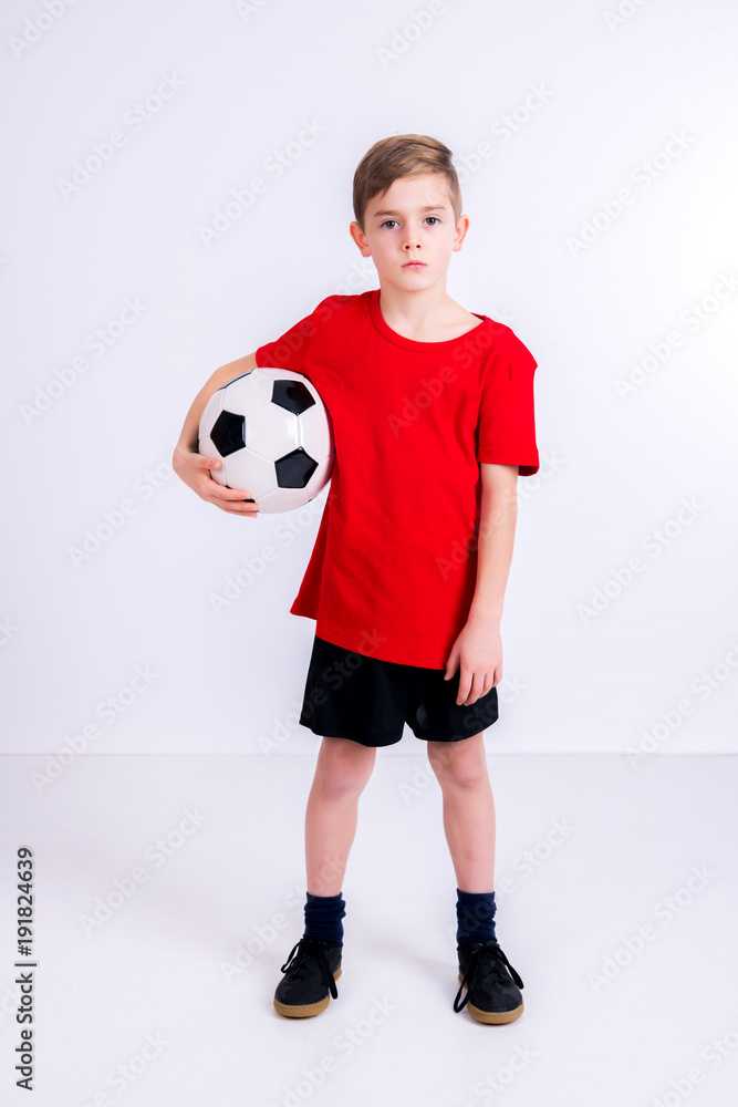 boy in red shirt with soccer ball