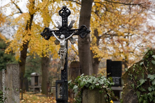 A cross with Jesus Christ in an old cemetery in Prague