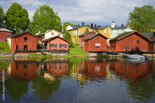 Red old barns on the river bank on a sunny summer day. Old Porvoo, Finland © sikaraha