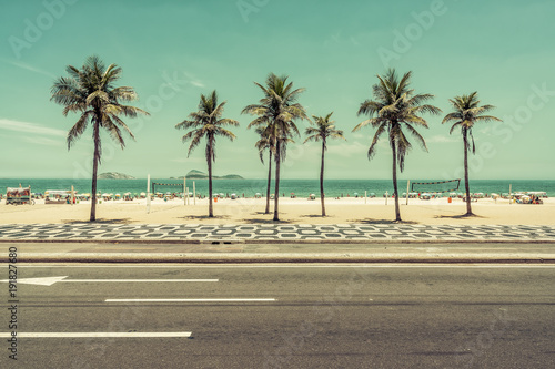 Sunny day with Palms on Ipanema Beach in Rio de Janeiro, Brazil. Vintage colors
