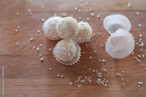 Homemade coconut candy on the light wooden background