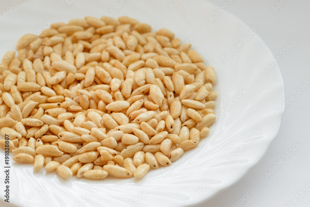 Puffed rice in white cup on white background. Puffed rice in white cup on white background.