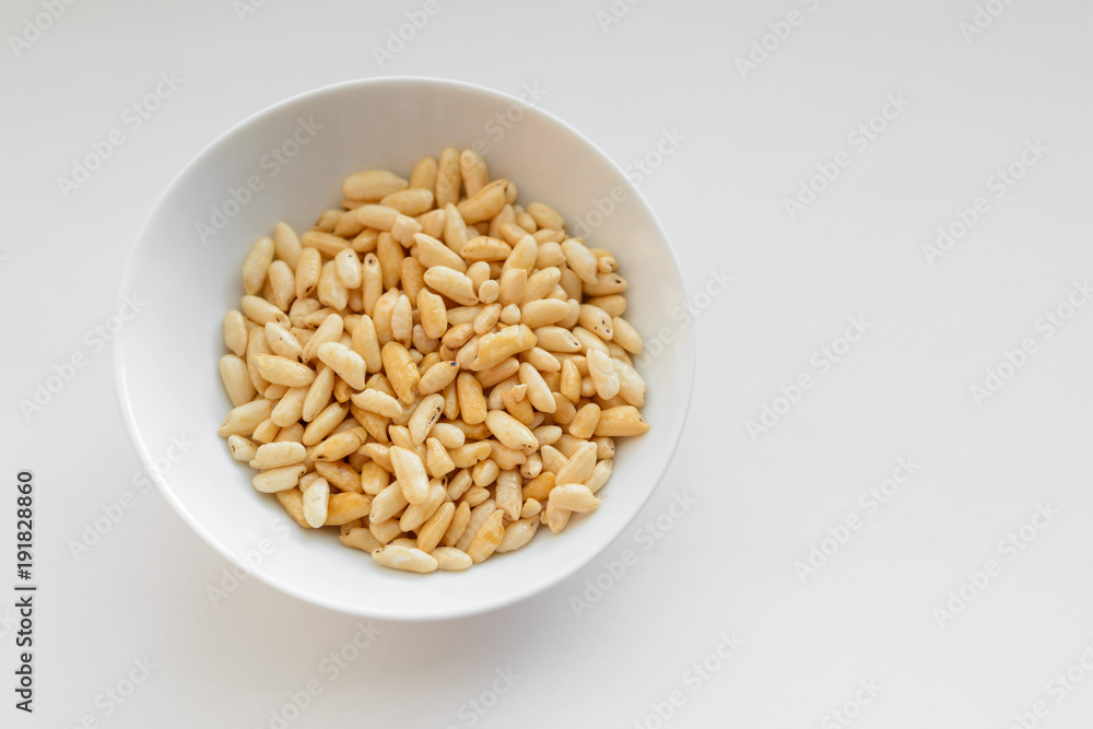 Puffed rice in white cup on white background. Puffed rice in white cup on white background.