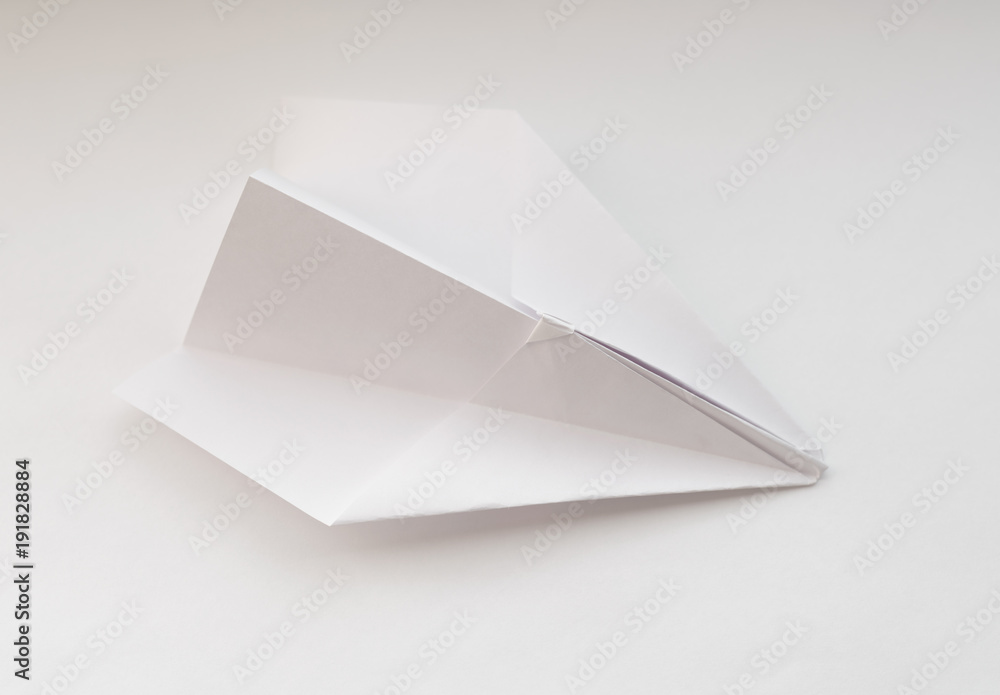 Paper plane on white background. Selective focus. Paper plane on white background. Selective focus.