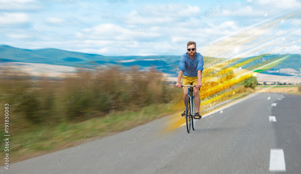 Fototapeta premium Young riding bicycle in nature