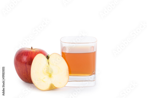 Apple cider vinegar in a glass cup and fresh apples on white background.