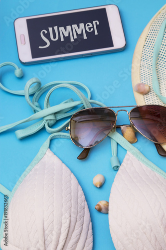 summer accessories, hat, seashells, bikini, sunglasses and mobile phone