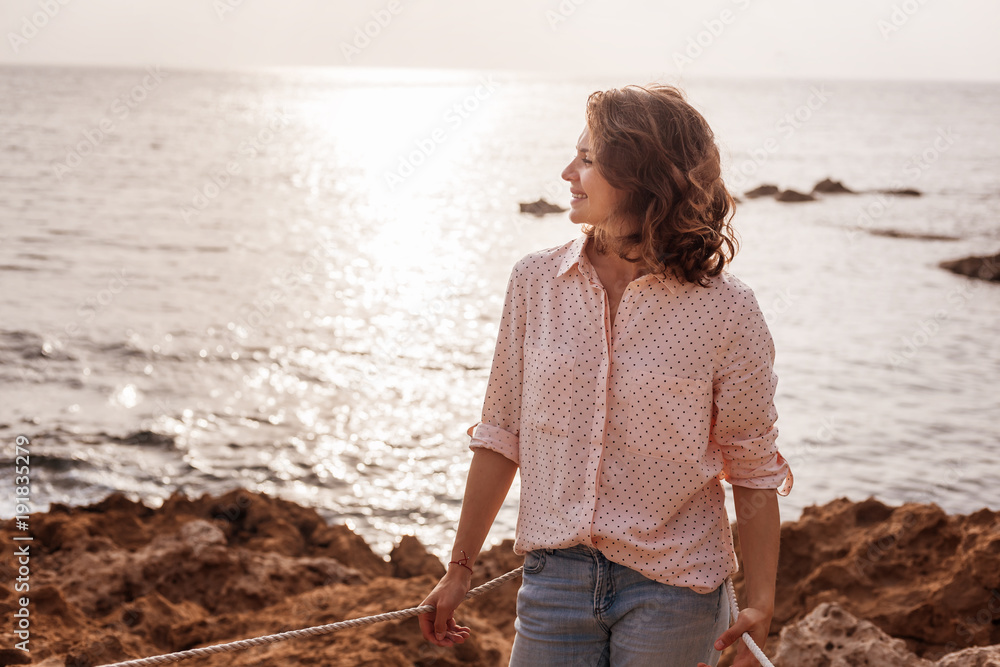 Beautiful Young Curly Stylish Girl In Jeans And A Pink Shirt On The