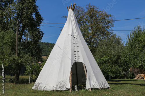 Wigwam in American style pitched in the field © leomalsam