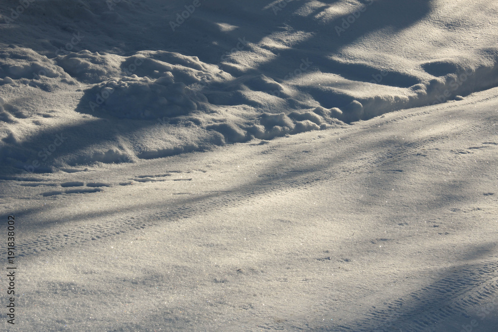 Snowy and plowed winter street in sunlight Snowy and plowed winter street in sunlight