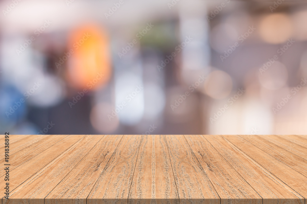 Empty wood table in front with blurred background of coffee shop,space for montage you product Empty wood table in front with blurred background of coffee shop,space for montage you product