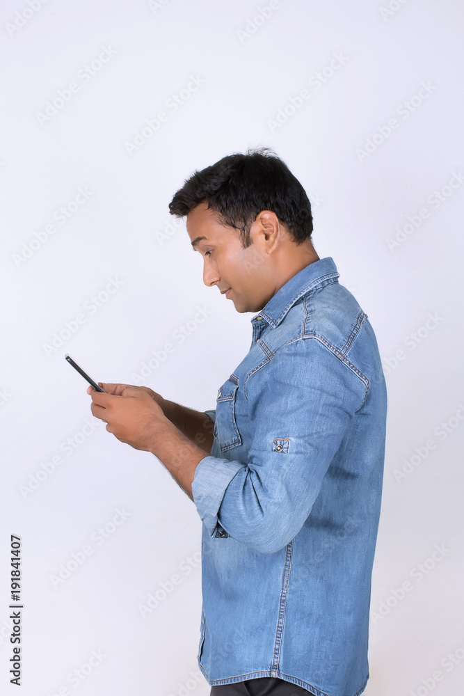 Young man operating smartphone Young man operating smartphone