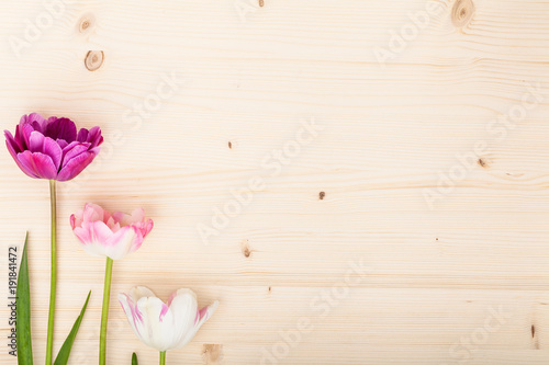 Fototapeta Naklejka Na Ścianę i Meble -  garden flowers tulips on wooden rustic table background with copy space for your text. vintage card, flat lay, top view. wedding, Mothers day or Womens day composition