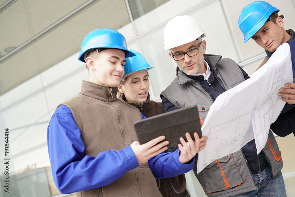 Construction manager giving instructions to training students Construction manager giving instructions to training students