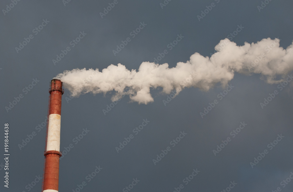 Pipe and smoke against the sky. Smoke over the city. Ecology