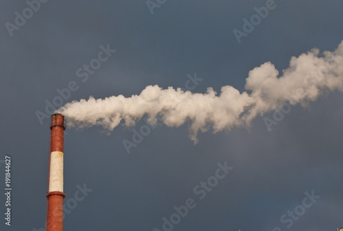 Pipe and smoke against the sky. Smoke over the city. Ecology