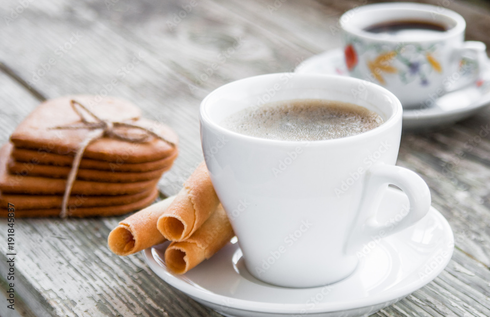 White cup of coffee with biscuits. White cup of coffee with biscuits.