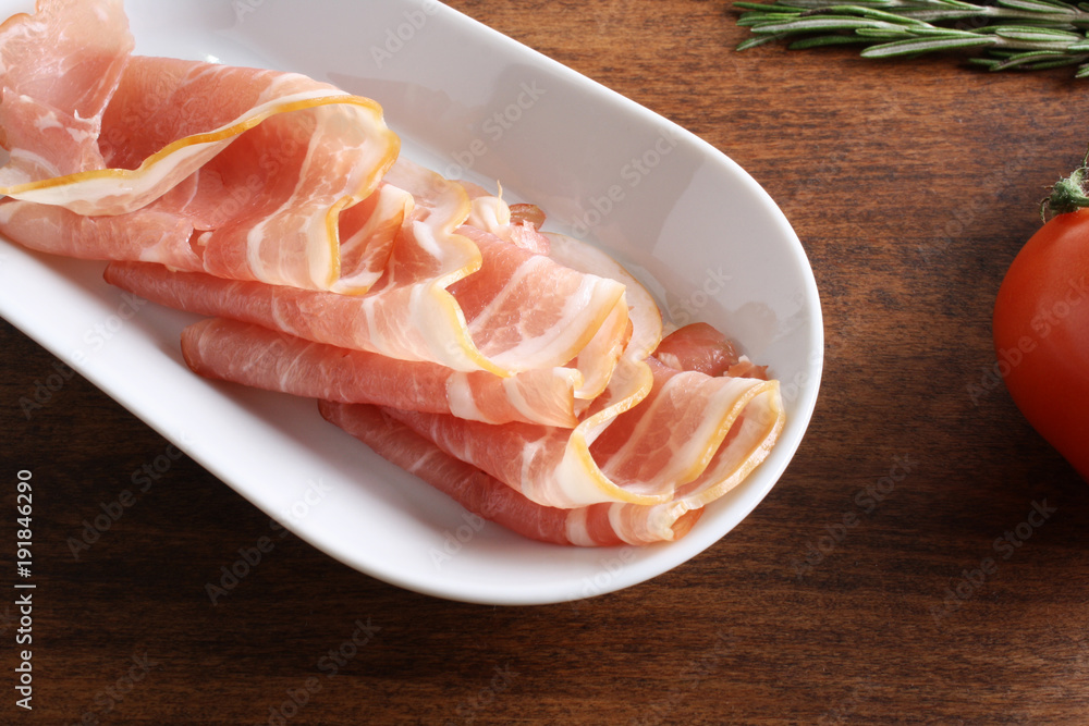 bacon sliced on a wooden background bacon sliced on a wooden background