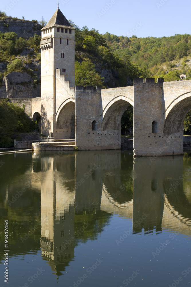 Europe, France, Midi Pyrenees, Lot, Cahors, the historic Pont Valentre fortified bridge reflected in the Lot River