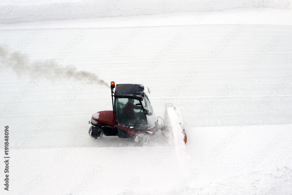 An ice skating piste and ice skating machine cleaning the snow in the alps switzerland in winter An ice skating piste and ice skating machine cleaning the snow in the alps switzerland in winter