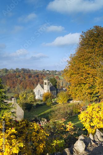 Unusual Italianate style church surrounded by golden autumn colour in Frampton Mansell, Gloucestershire, UK