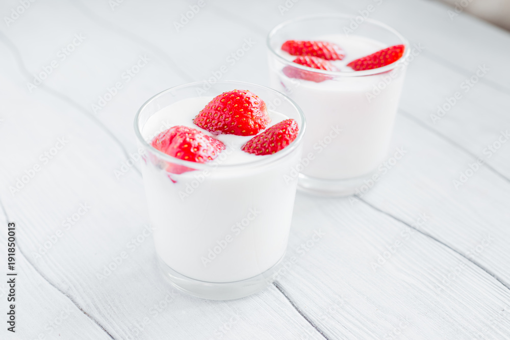Eating healthy breakfast .Yogurt with strawberries on the table Eating healthy breakfast .Yogurt with strawberries on the table