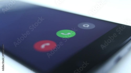 Incoming phone call indication on smartphone display close-up, Answering an incoming call