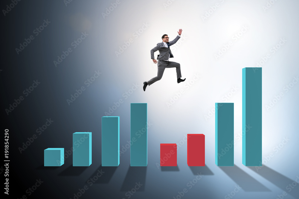 Young businessman in business concept with bar charts Young businessman in business concept with bar charts