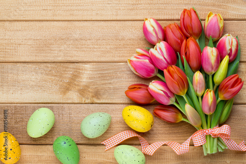 Fototapeta Naklejka Na Ścianę i Meble -  Spring easter tulips in bucket on wooden vintage background.