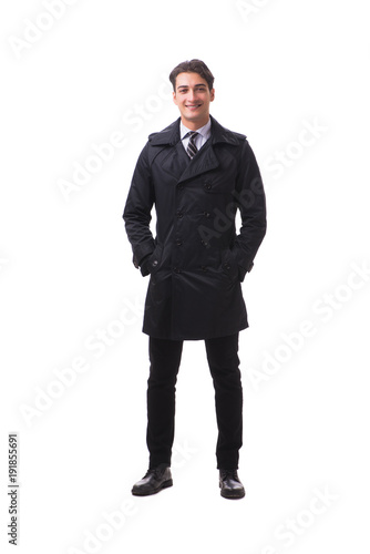 Young businessman wearing winter coat isolated on white © Elnur