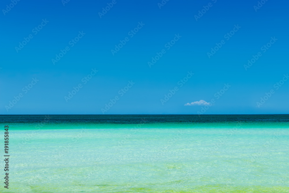 Turquoise sea water and blue sky background.