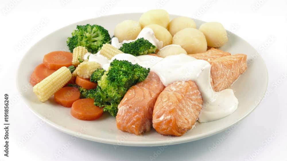 Sauce Poured On Meal Of Salmon, Potatoes And Vegetables Sauce Poured On Meal Of Salmon, Potatoes And Vegetables