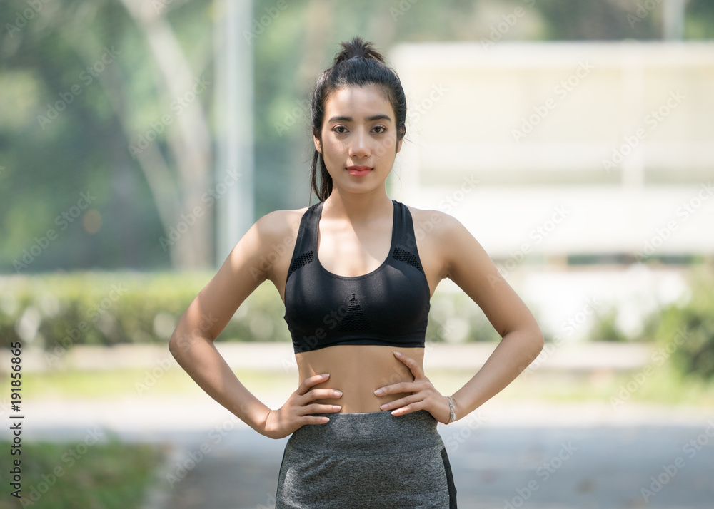 front view of young fitness woman running on the road in the morning, People and sport concept, Selective focus