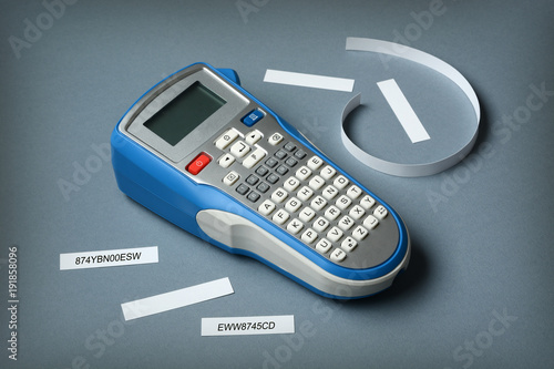 labeler with labels beside on gray table