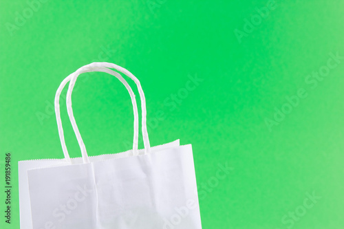 white shopping bags on green background