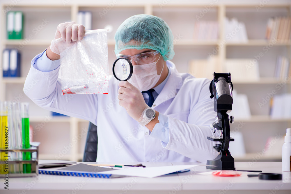Forensics investigator working in lab on crime evidence Forensics investigator working in lab on crime evidence