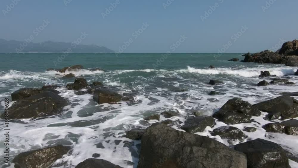 Ocean waves lapping the coastline on south china sea in central Vietnam with a blue sky high definition movie footage. Ocean waves lapping the coastline on south china sea in central Vietnam with a blue sky high definition movie footage.