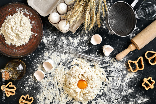 Woman smashes an egg using knife while kneading a pastry. Studio shot. Top view © nazarovsergey