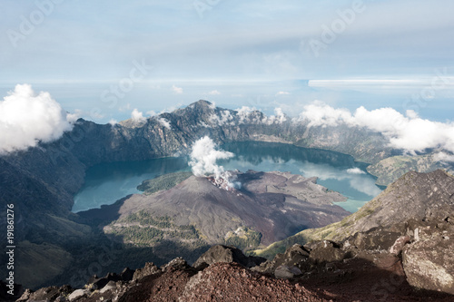 Rinjani crater lake from the above with levitating cloud and mountain around, Lombok, Indonesia