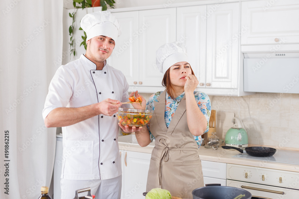 Funny senior chef with big white hat and pot of beans Funny senior chef with big white hat and pot of beans