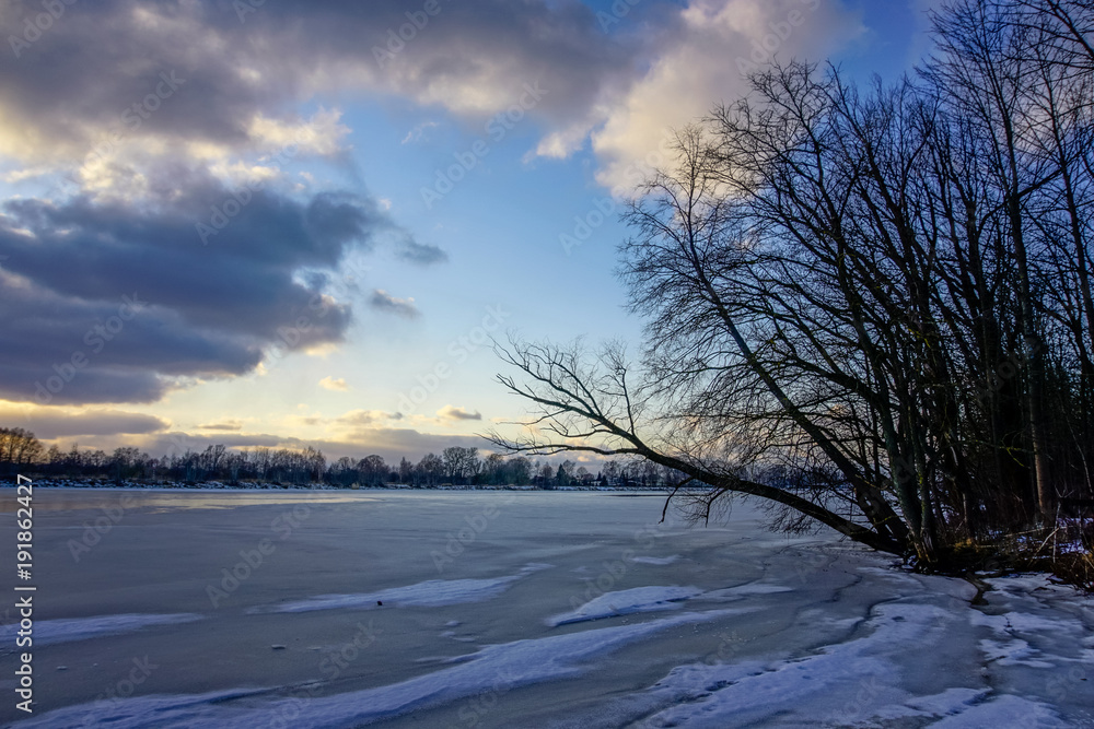 colorful winter sunset on frozen river ice colorful winter sunset on frozen river ice