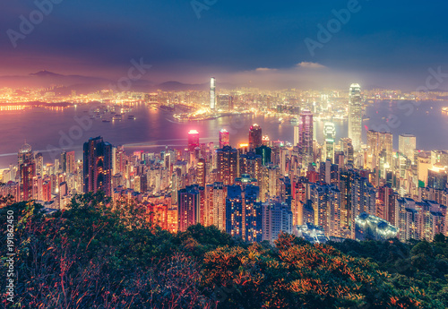 Scenic view over Hong Kong island, China, by night. Multicolored nighttime skyline with illuminated skyscrapers seen from Victoria Peak © Funny Studio
