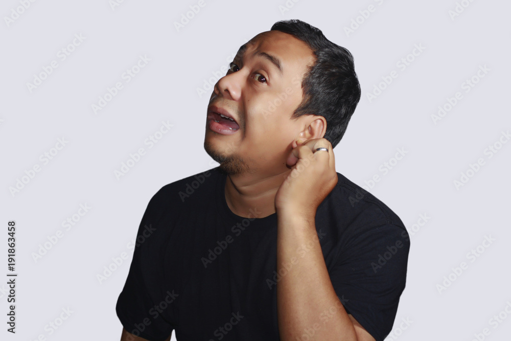 Portrait of an asian man sick his ear.hearing problems Portrait of an asian man sick his ear.hearing problems